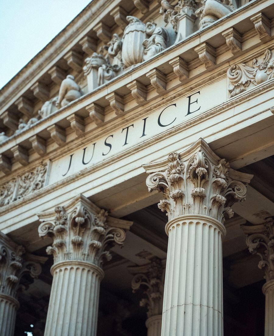 Courthouse facade engraved with the word Justice